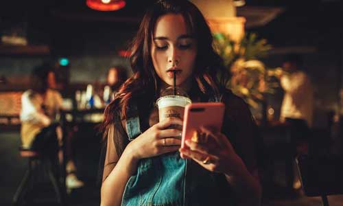 5 Things You Can Do in An Irish Pub woman phone - 5 Things You Can Do in An Irish Pub